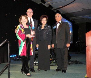 The Silicon Valley Association of REALTORS® (SILVAR) received the platinum award from the National Association of REALTORS® for its global council program at the 2013 REALTORS® Conference & Expo in San Francisco. Pictured here are (left to right) SILVAR president Carolyn Miller and executive officer Paul Cardus, who received the award from Nancy Suvarnamani and Furhad Waquad, 2014 and 2013 chair, respectively, of the NAR Global Business and Alliances Committee. 